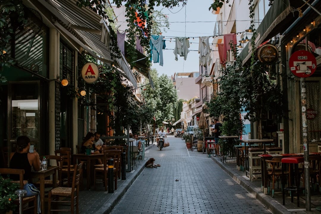 Café tables filling a pedestrian street in the Koukaki district of Athens
