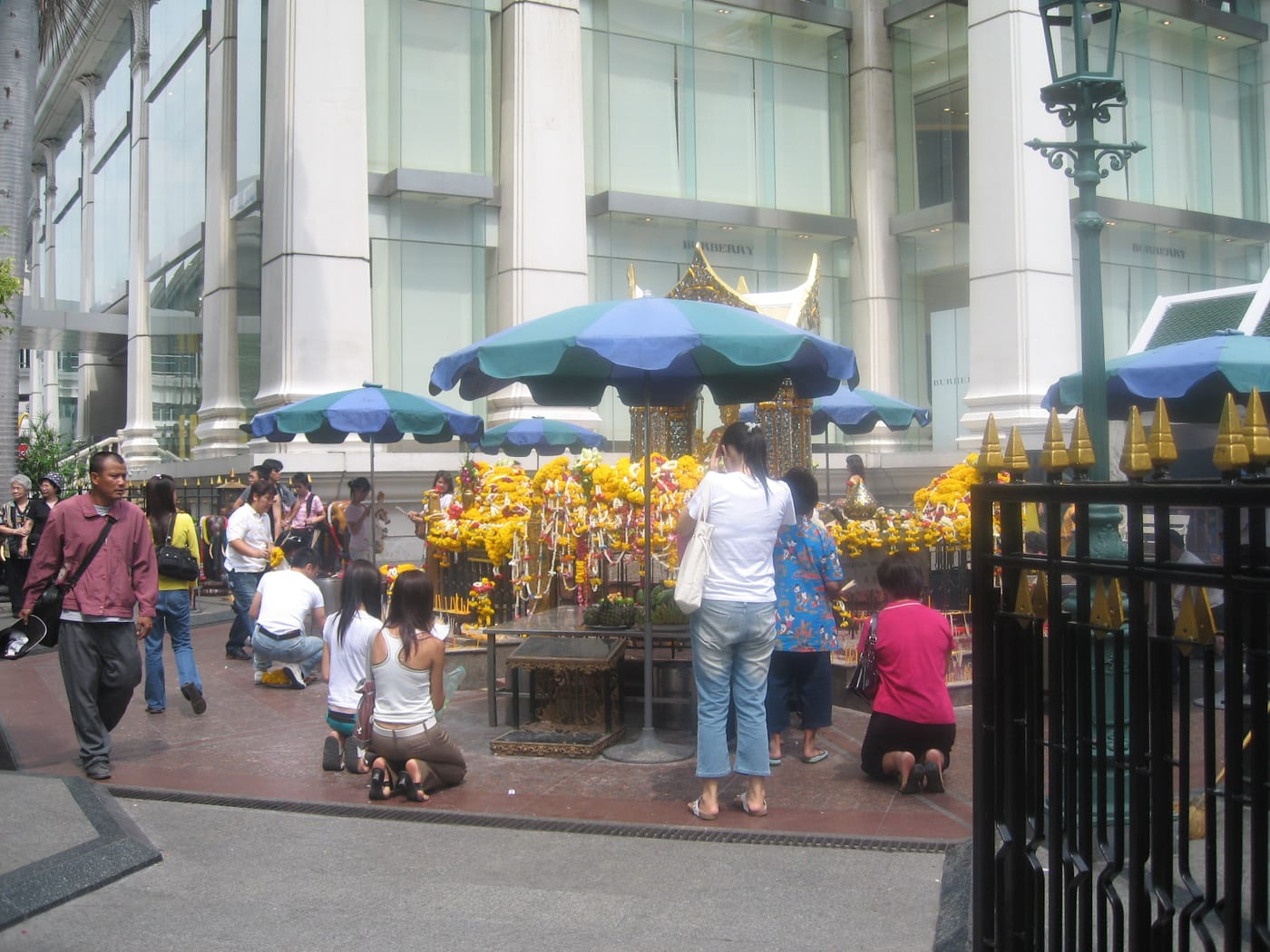 Worshippers leaving marigold garlands at the Erawan Shrine in Bangkok