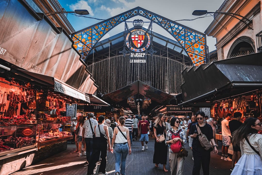 Colour-stacked produce and seafood counters inside La Boqueria market