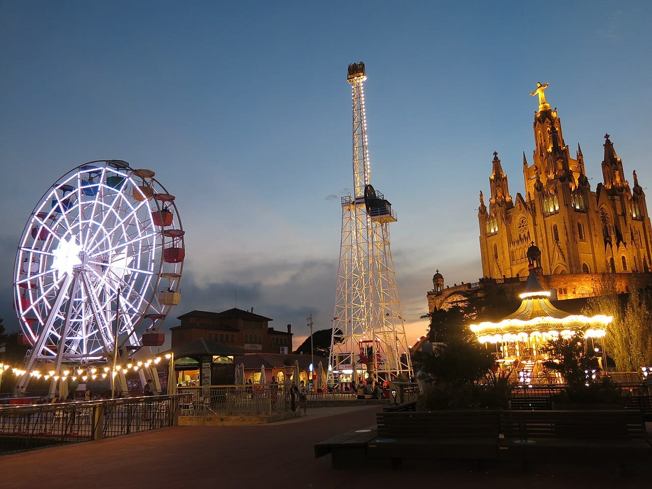 The Tibidabo funfair ferris wheel and church silhouetted at dusk above Barcelona