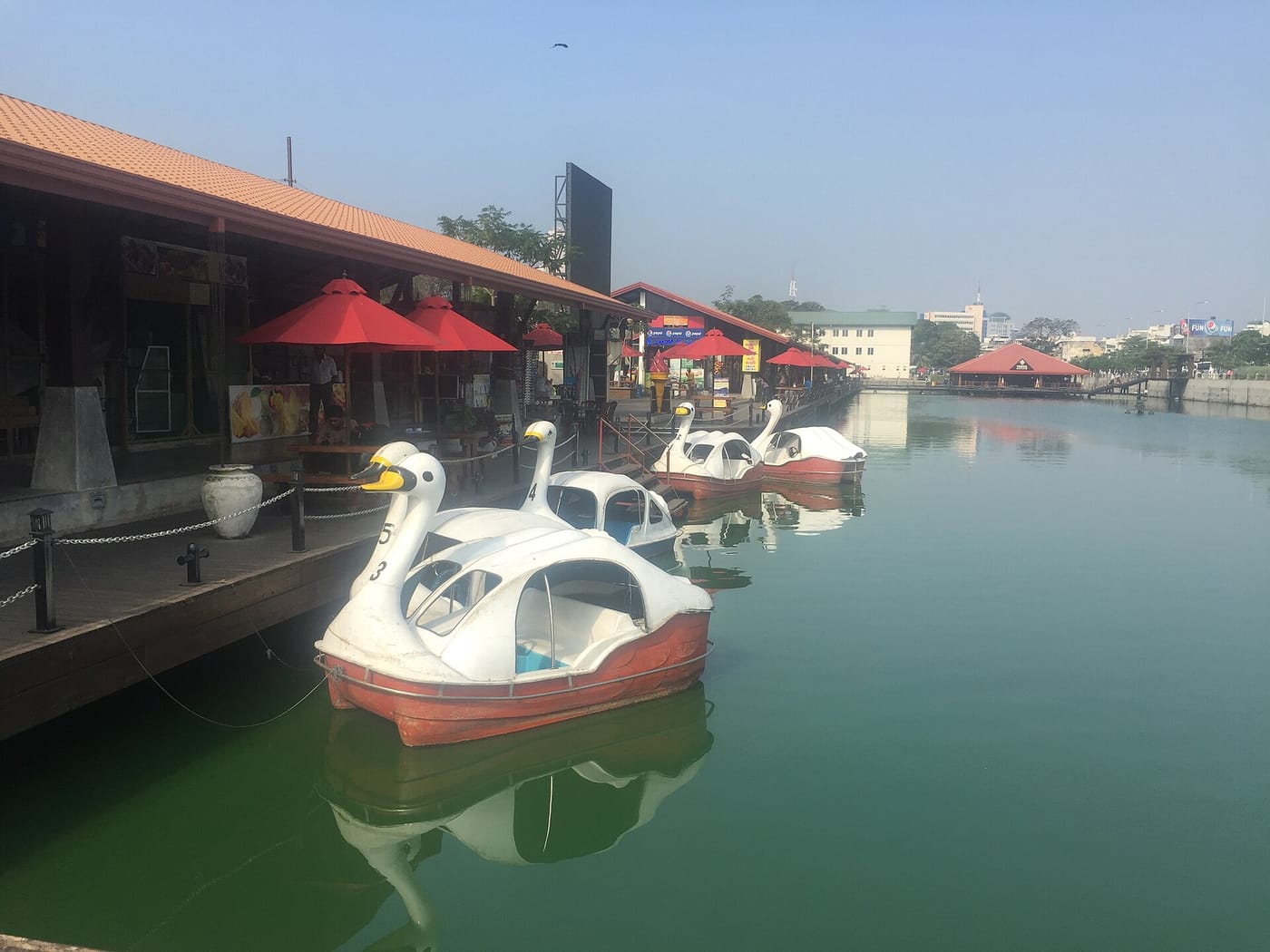 Shops and boats along the canal at the Pettah Floating Market in Colombo