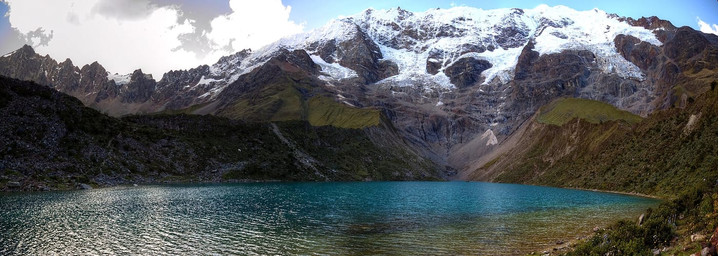 The turquoise glacial Humantay Lake beneath snow peaks near Cusco