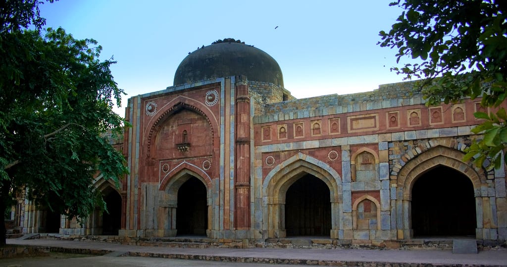 A domed tomb among trees in the Mehrauli Archaeological Park, Delhi