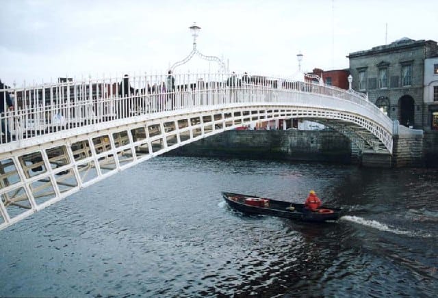 The white cast-iron Ha'penny Bridge over the River Liffey in Dublin