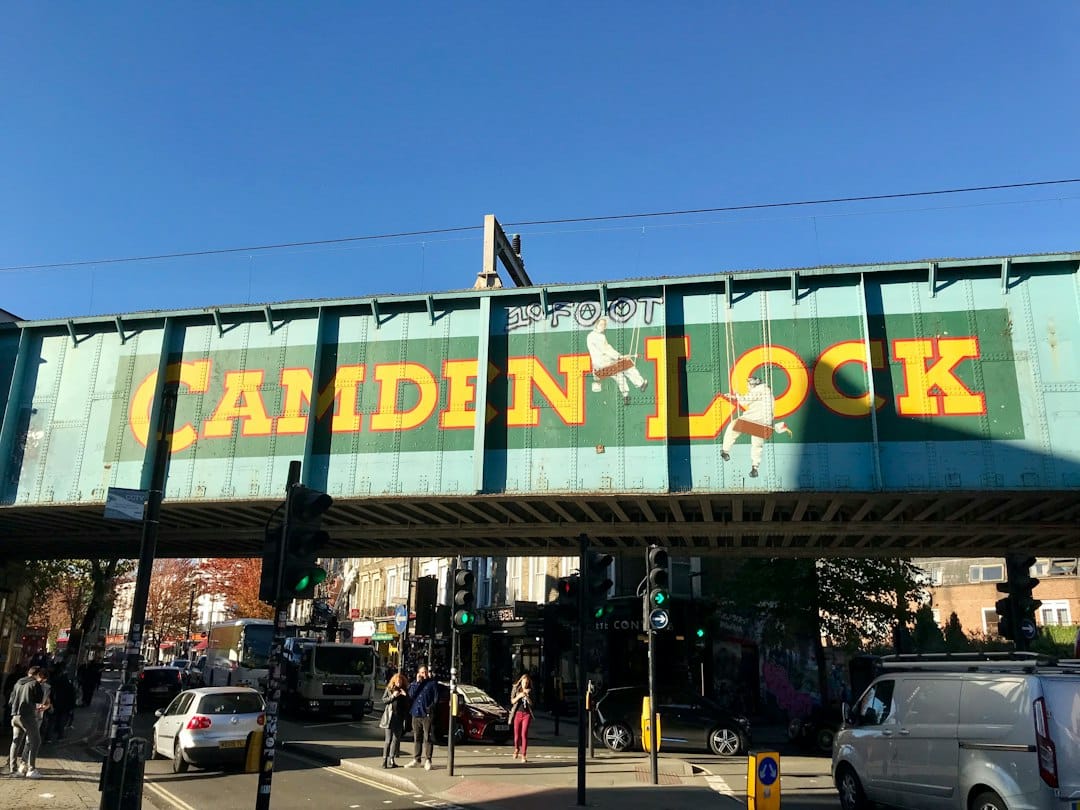 The green Camden Lock market bridge sign over the street in London
