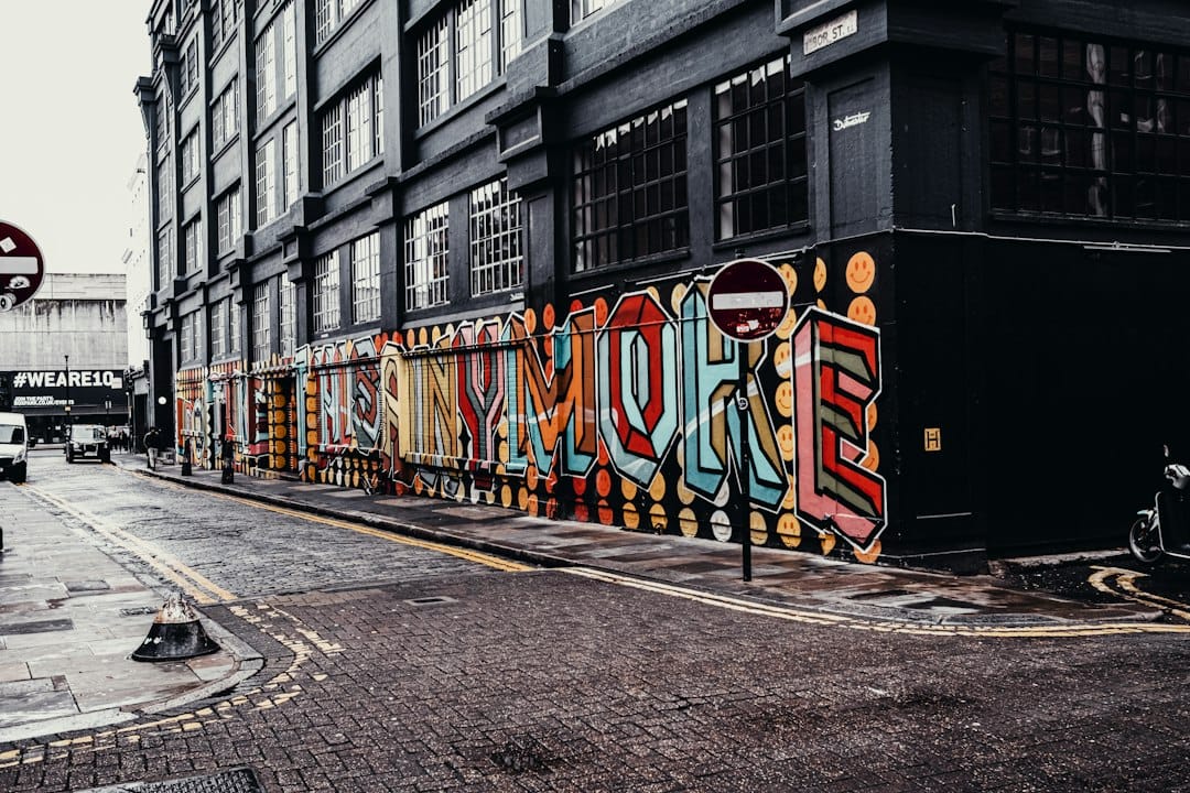A large colourful street-art mural on a wall in Shoreditch, London