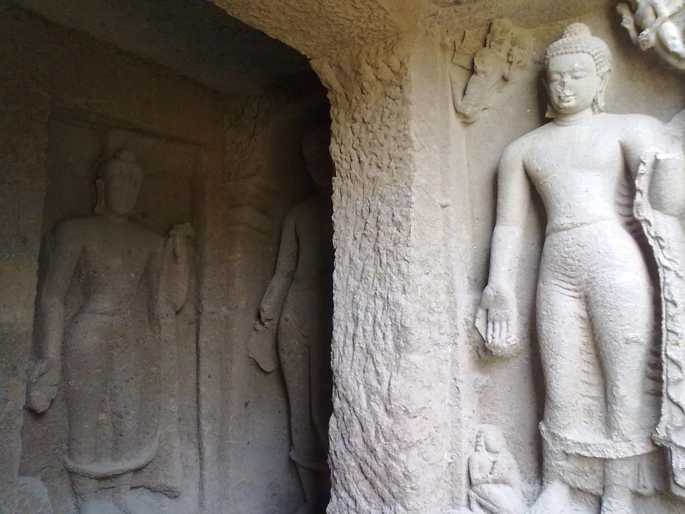 A carved Buddha in the rock-cut Kanheri Caves near Mumbai
