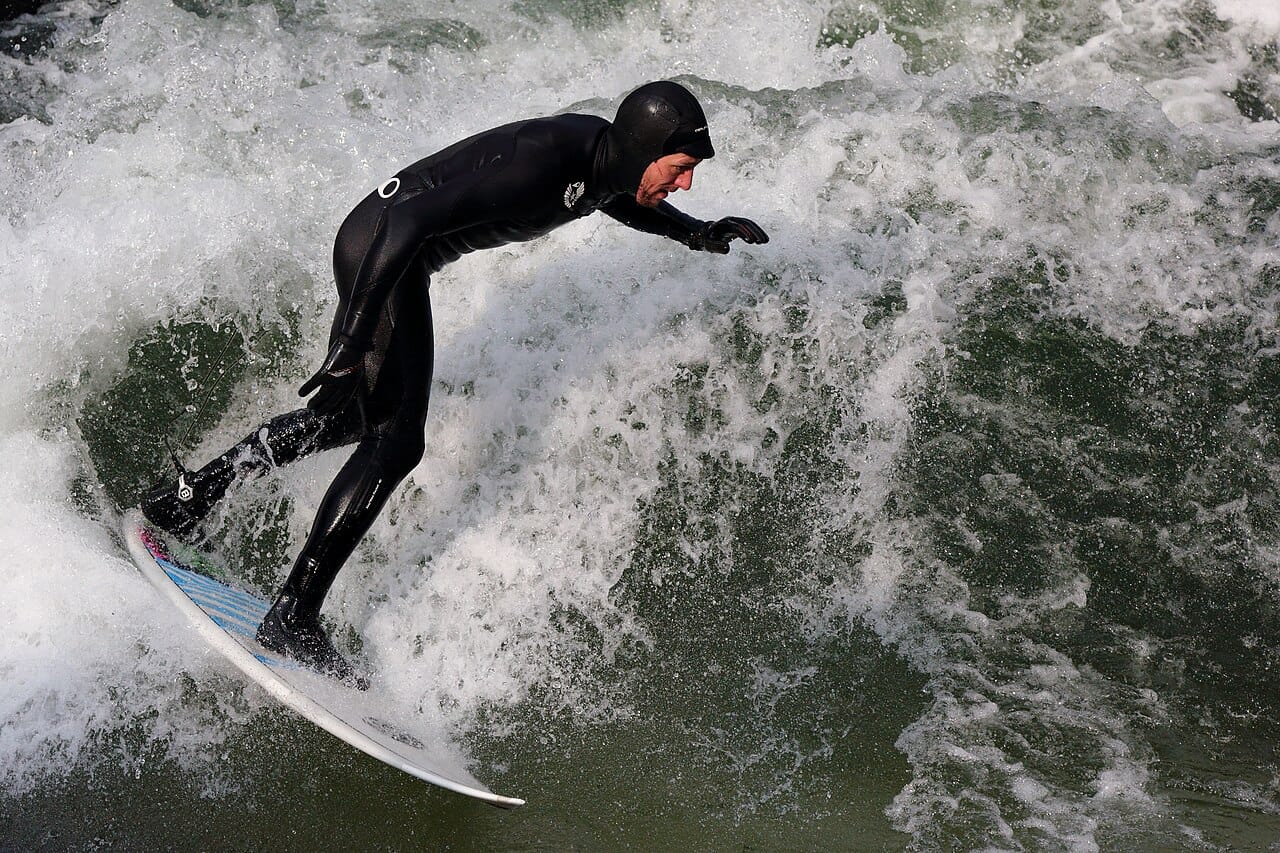 Surfers on the Eisbach wave in the English Garden, Munich