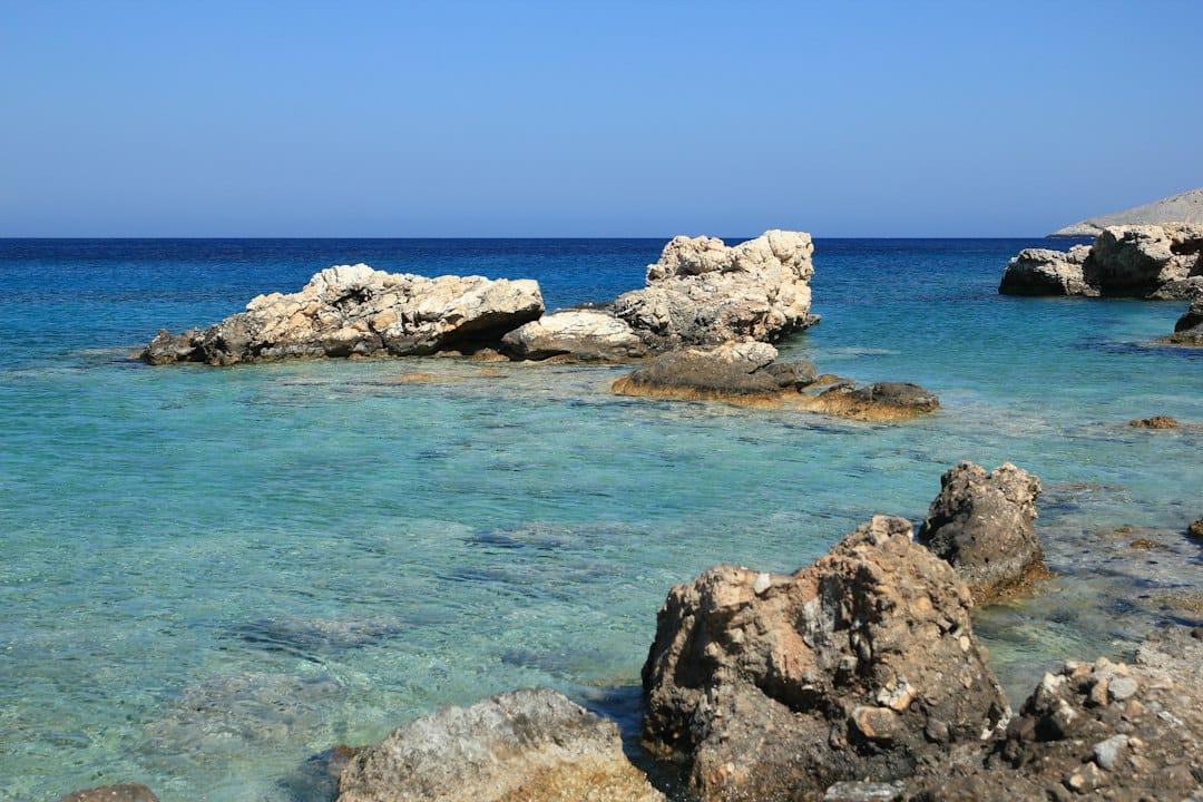 The wild rocky cove and turquoise water of Fokos beach on Mykonos