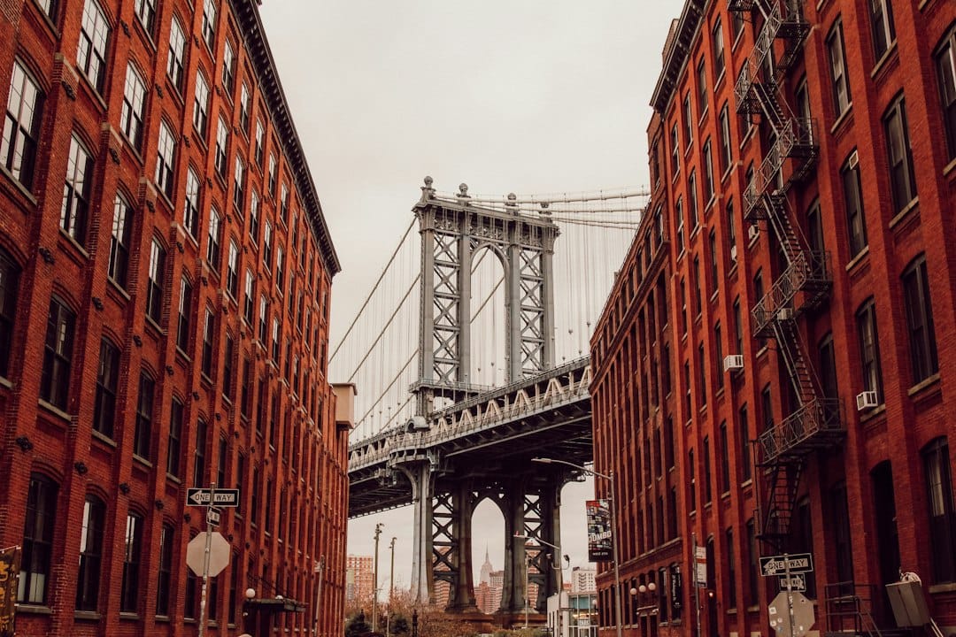 The Manhattan Bridge framed by brick buildings on Washington Street in DUMBO, Brooklyn