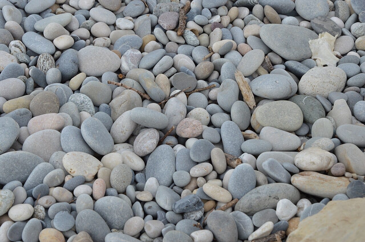 The pebble beach and blue water of the Baie des Anges, Nice