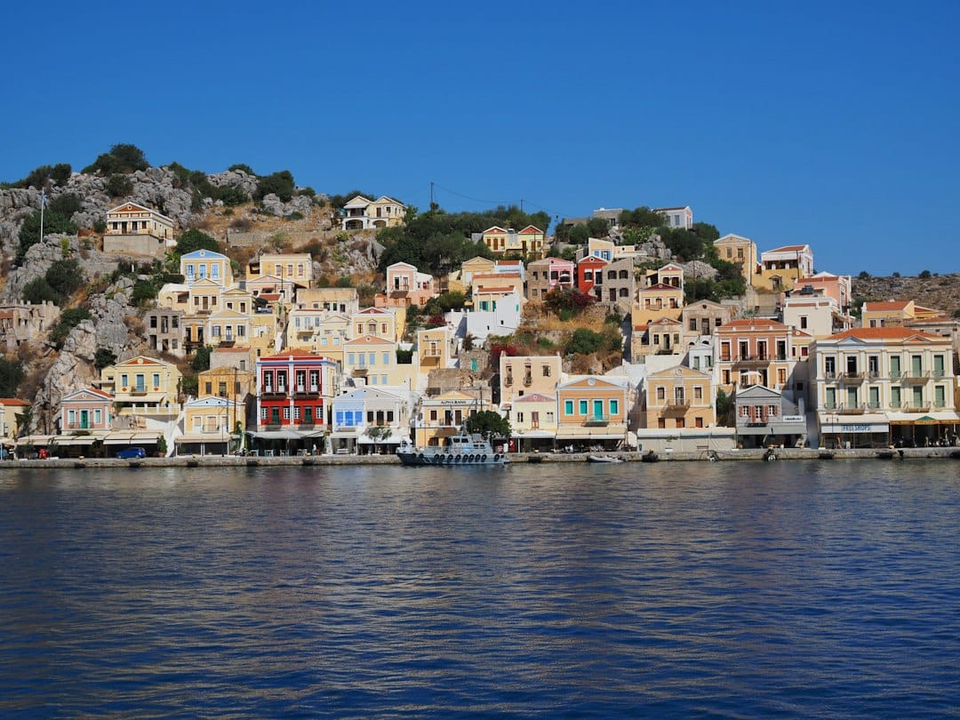 The pastel neoclassical houses rising from the harbour of Symi island