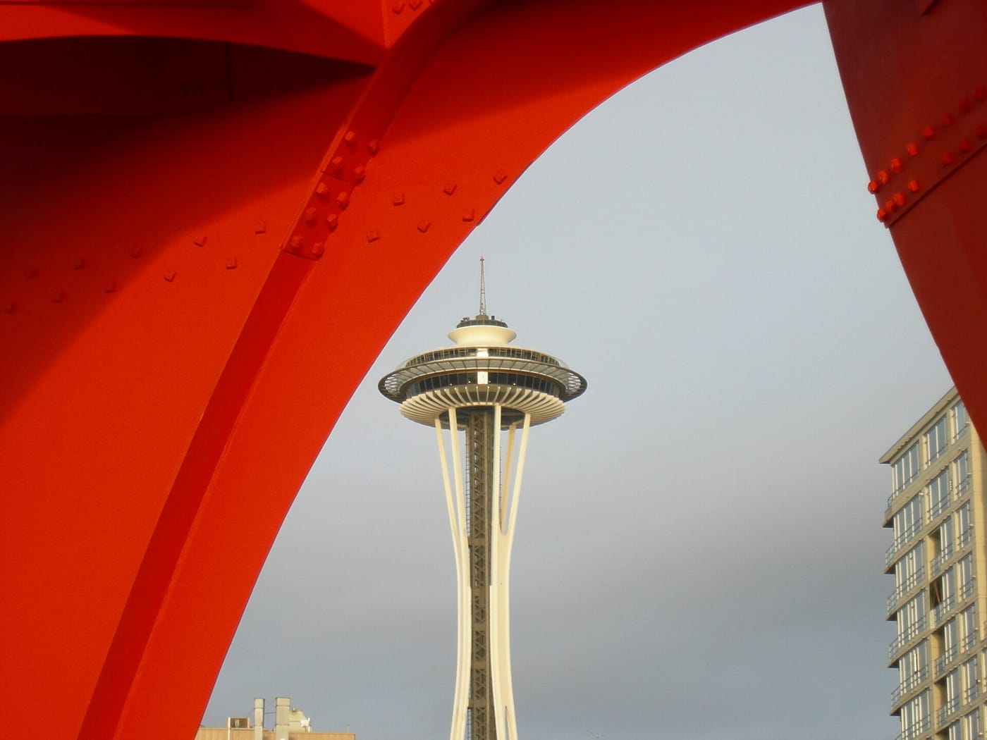 A large sculpture framing the Space Needle at the Olympic Sculpture Park, Seattle