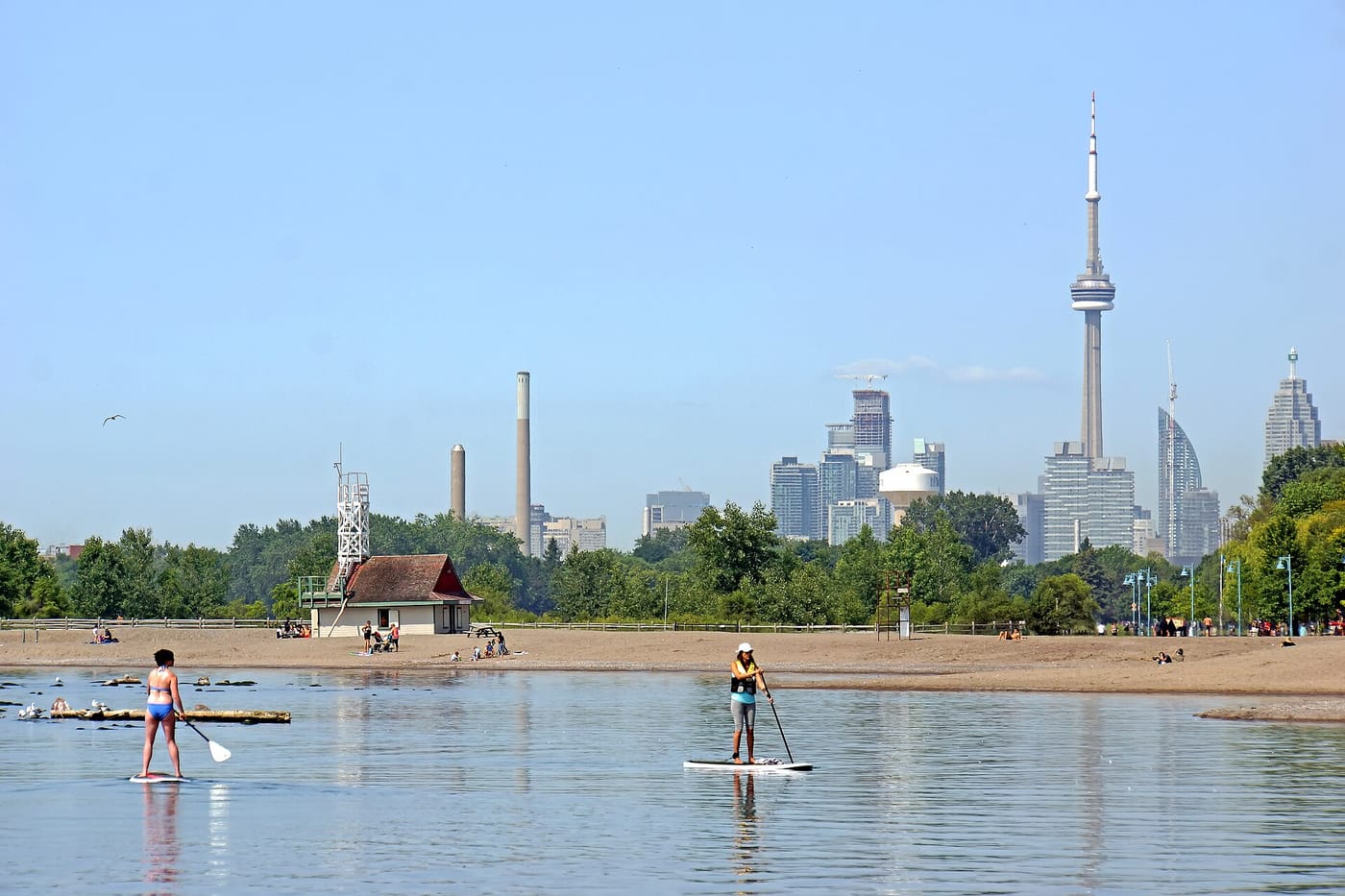 Paddleboarders and the boardwalk at The Beaches in Toronto